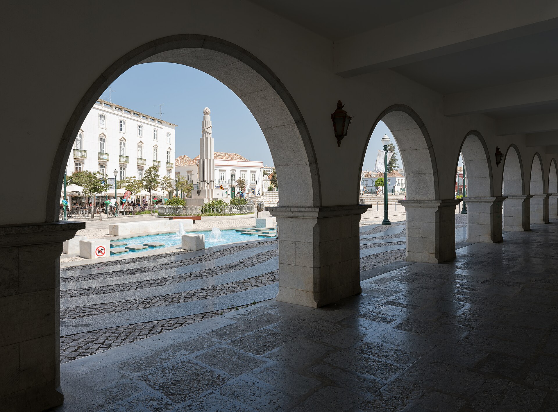 The arches of Tavira’s town hall framing the riverside square